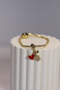 Pulsera plateada con dije de perro en oro